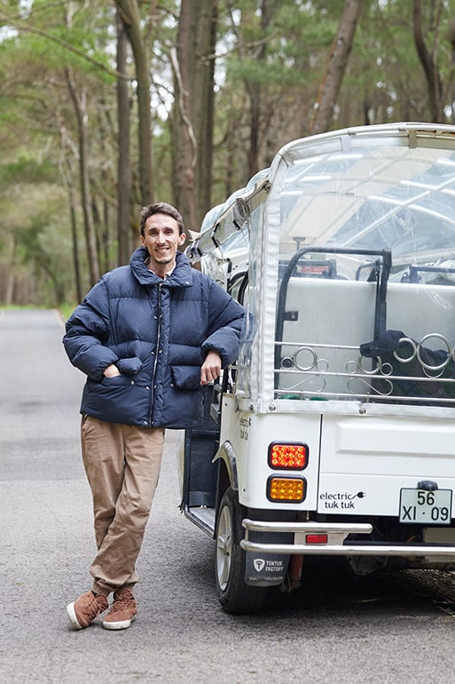 Daniel Ponce, founder and private tour guide in Sintra, standing beside an electric tuk tuk during a private tour