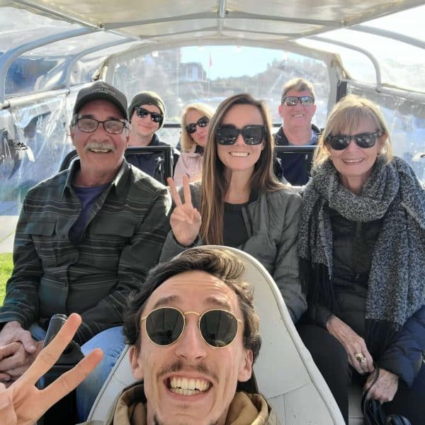 Happy group enjoying a private electric tuk tuk tour in Sintra with Daniel Ponce from Yes, You Deserve! — sunshine, smiles and unforgettable views in Portugal.
