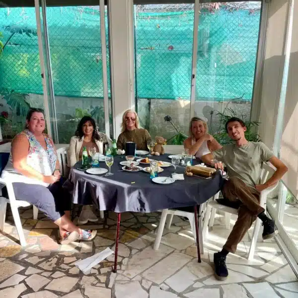 Private lunch experience during a Yes, You Deserve! tour in Sintra, Portugal – group of travelers enjoying local food, wine, and great conversation in a cozy, sunlit setting.