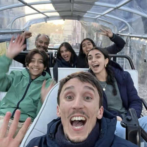 Family enjoying a private tuk tuk tour in Sintra with Daniel Ponce from Yes, You Deserve! – smiles and fun during a magical ride through Portugal’s scenic town.