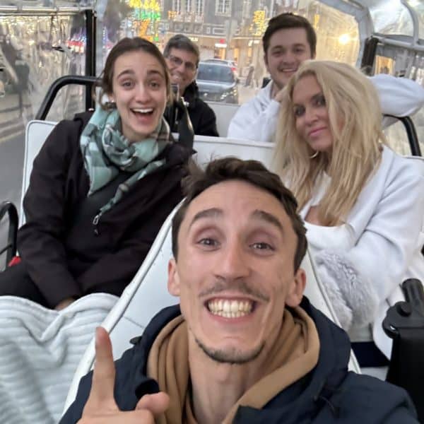 Private winter tuk tuk tour in Sintra with Daniel Ponce from Yes, You Deserve! – happy travelers bundled up for a magical evening ride through Portugal's charming town.