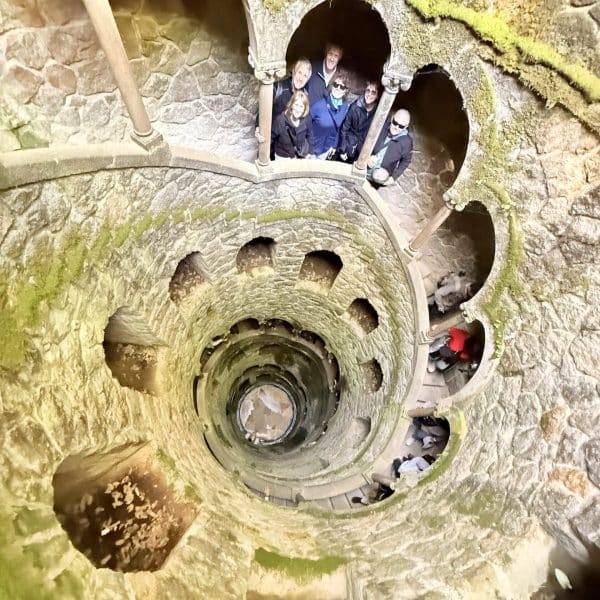 A cruise guest exploring the initiation well in quinta da regaleira in one of our tuk tuks — just 45 minutes after leaving Lisbon port.