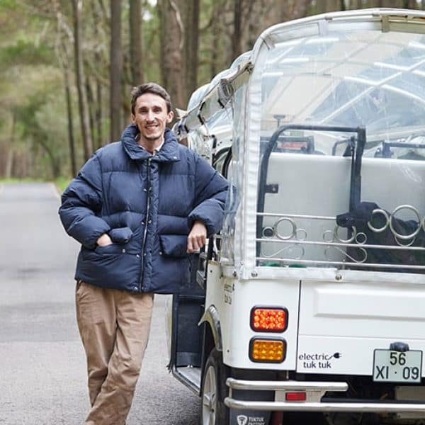 Daniel Ponce, founder and private tour guide in Sintra, standing beside an electric tuk tuk during a private tour